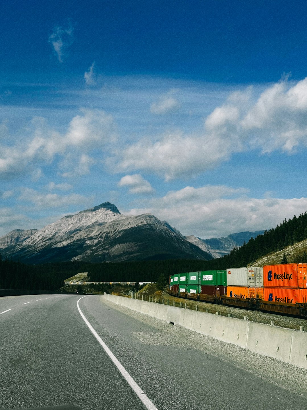 freight-train-with-colorful-containers-travels-by-mountains-ss5vk35dd7w